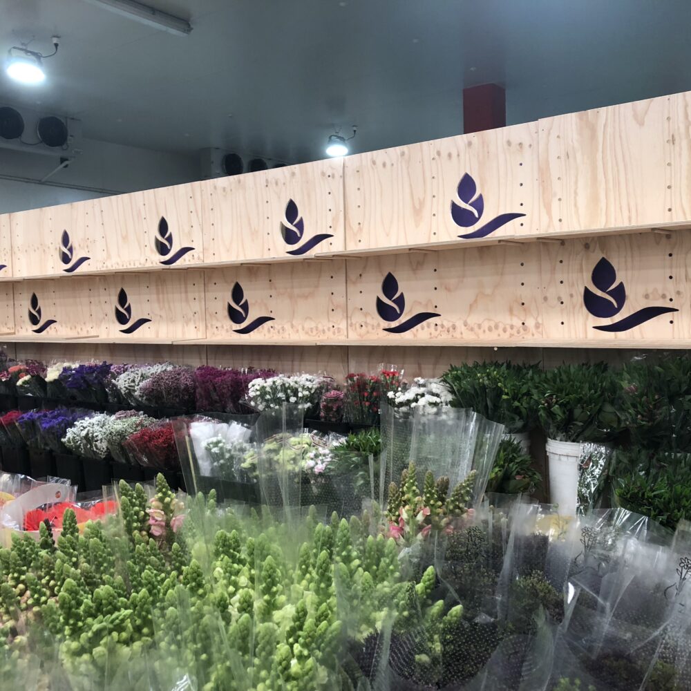 Tony's Wholesale Flowers Engraved Logo Wall and bins